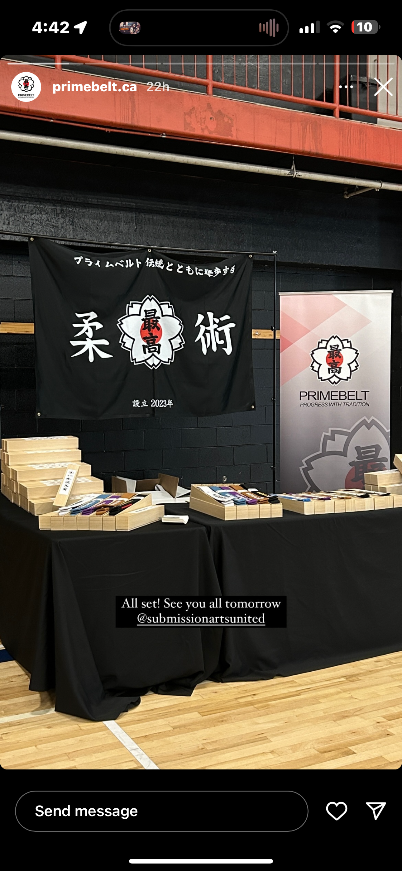 Primebelt banner and roll-up display at an event booth